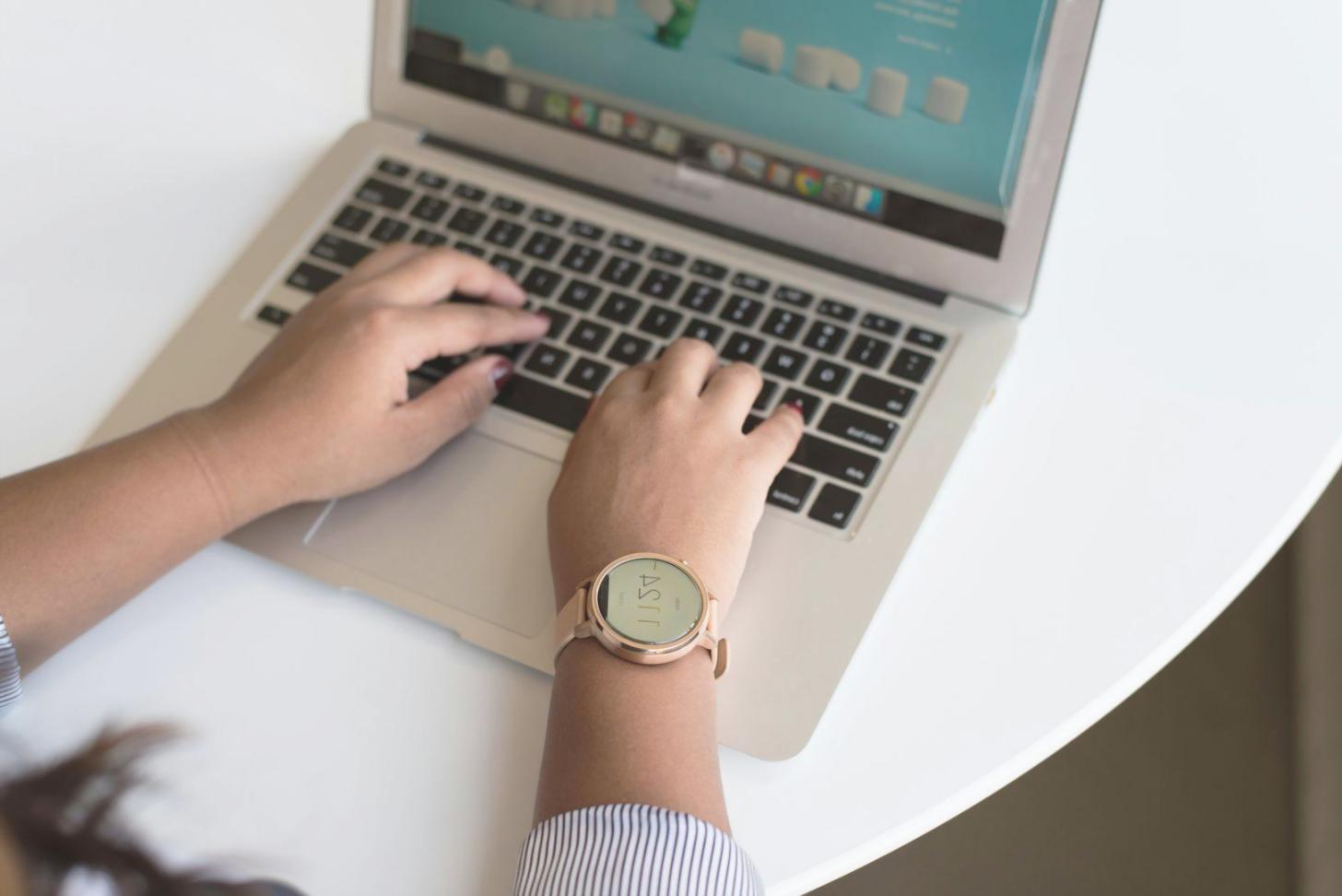 Remote learning workspace setup showing organized desk with coding materials and natural lighting